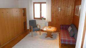 a living room with two chairs and a table at Ferienwohnung Hörnle Bad Kohlgrub in Bad Kohlgrub