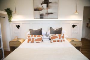 a bedroom with a white bed with two pillows at Abode Above at Tor View in Padstow