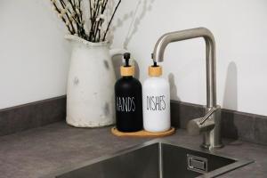two bottles on a kitchen counter next to a sink at Abode Above at Tor View in Padstow +46 photos