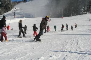 a group of people skiing down a snow covered slope at Résidence du Château Lublin in La Bresse