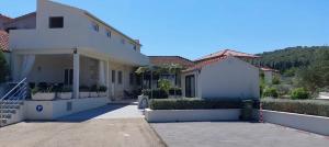a white house with a lot of potted plants at Apartment "MANNA in Korčula