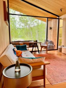 a living room with a couch and a table at The Grit - Adults-Only Modern Design House near Brașov in Vama Buzăului