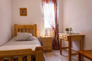 Postel nebo postele na pokoji v ubytování Hostal Sango Sierra de las Nieves