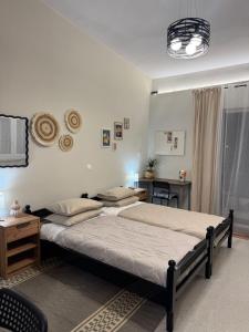 a bedroom with two beds and a desk in it at Bougainvillea Terrace Studio in Sikéa