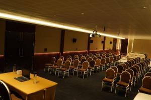 a room with rows of chairs and tables in a room at Moonlight Resorts Idappadi in Ammāpettai +124 photos