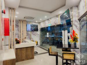 a lobby with a counter and a dining room at IPOH AVS HOTEL by VERVE in Ipoh +81 photos