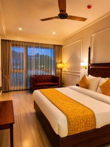 a hotel room with a large bed and a window at Tiraya Luxury Riverside Hotel & Café in Gushaini