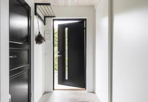 a black door in a room with a hallway at Comfy Modern Guesthouse in Bankeryd