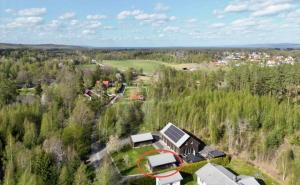 an aerial view of a house in a forest at Comfy Modern Guesthouse in Bankeryd +1 photo