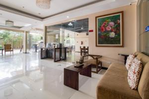 a living room with a couch and a table at Main Hotel and Suites Cebu in Cebu City