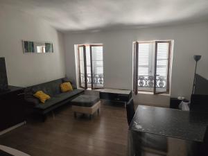 a living room with a couch and a table at superbe t3 in Cognac
