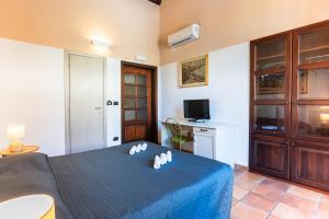 a bedroom with a bed and a desk and a television at Via Roma Rooms Guesthouse in Sassari