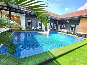 a swimming pool in the backyard of a house at Tiki Pool Pattaya in Ban Nong Pla Lai +70 photos