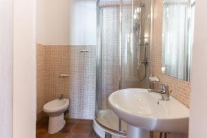 a bathroom with a sink and a toilet and a shower at Via Roma Rooms Guesthouse in Sassari