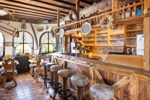 a restaurant with a bar with wooden walls and stools at Hapimag Ferienwohnungen Sonnleitn in Sonnenalpe Nassfeld
