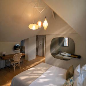 a bedroom with a bed and a desk and a table at Les Villas de la Ville d'Hiver Palissy et Velleda in Arcachon +135 photos