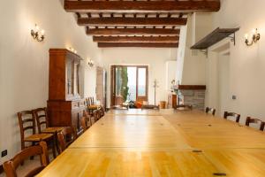 a large room with a large wooden table and chairs at Casale Santa Francesca by PosarelliVillas in Campiglia dʼOrcia +72 photos