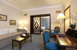 a living room with a couch and a table at Hotel Lisboa Plaza - Lisbon Heritage Collection - Avenida in Lisbon