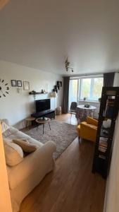 a living room with a couch and a table at Arena apartment in Panevėžys