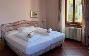 a bedroom with a bed with two pillows on it at Villa Torre - Atmosfera Romantica in Brenzone sul Garda +104 photos