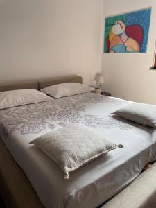 a bed in a bedroom with a picture on the wall at MONTECAMPI casa di charme in Meda