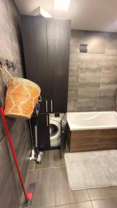 a small bathroom with a toilet and a sink at Arena apartment in Panevėžys
