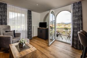 a living room with a view of a balcony at Hubertus Appartements Inzell in Inzell