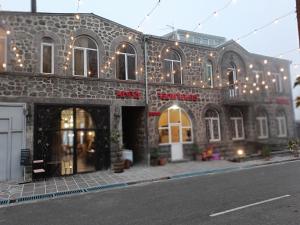 a building with christmas lights on the side of it at Кирч Горис in Goris
