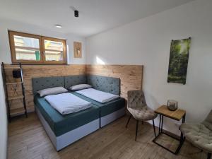 a bedroom with a bed and a chair in it at RoSa Haus in Steingaden +12 photos