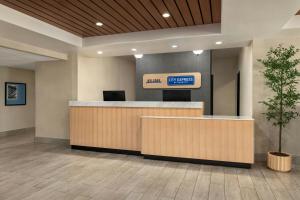 a lobby with a counter with a sign on it at City Express By Marriott Rancho Cucamonga in Rancho Cucamonga +28 photos
