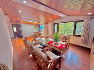 a living room with a table and chairs at Pinewood View Homestay in Shimla