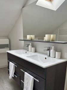 a bathroom with a sink and a mirror at Monet Garden Retreat in Giverny +24 photos