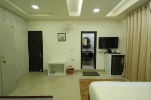 a room with a bed and a tv and a mirror at Hotel Quality Inn in Āīzawl
