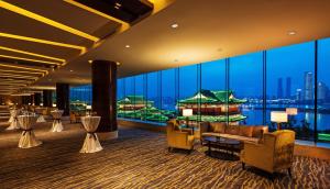 a hotel lobby with a view of the city at Swiss Grand Nanchang in Nanchang