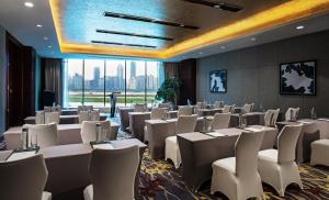 a conference room with white tables and chairs at Swiss Grand Nanchang in Nanchang +57 photos