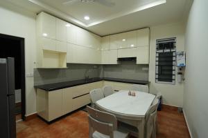 a kitchen with a white table and chairs in it at Hotel Quality Inn in Āīzawl