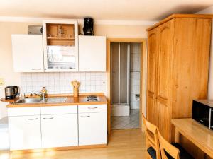 a kitchen with white cabinets and a sink at Einzelzimmer in Kelheim