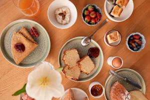 a table topped with plates of cake and desserts at Hôtel De La Vallée in Dinard +32 photos