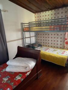 a room with two bunk beds and a bed at pti caze Hoarau in Le Tampon