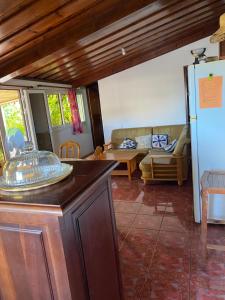a living room with a couch and a table at pti caze Hoarau in Le Tampon