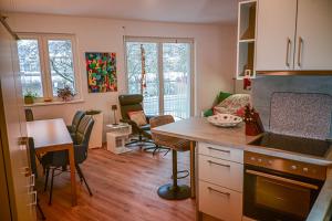 a kitchen and living room with a table and chairs at Mainresidenz Wertheim in Wertheim