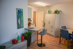 a kitchen with a table and chairs in a room at Mainresidenz Wertheim in Wertheim +12 photos
