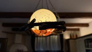 aendant light hanging from a ceiling in a room at Villa Di Mare in Mesimvría