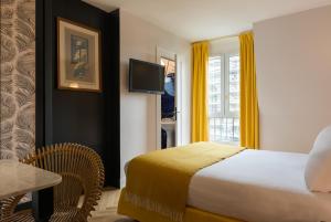 a bedroom with a large bed and a large window at Maison Malesherbes in Paris