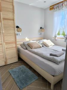 a bedroom with a large bed and a window at #MazuryOFFline in Giżycko