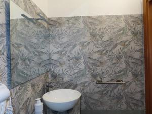 a bathroom with a toilet and a wall at B&B Casa Lamanna in Torretta +32 photos
