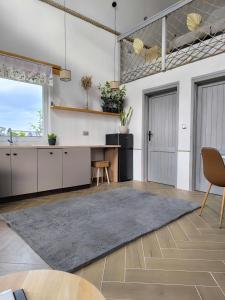 a kitchen with white cabinets and a table and a rug at #MazuryOFFline in Giżycko