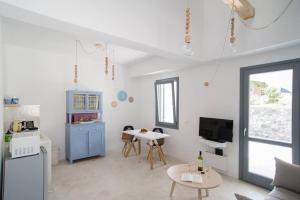 a living room with a couch and a table at Lagadi Suites Mesaria in Mesaria