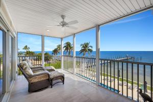 a screened porch with a view of the ocean at Captiva Hide A Way 2B in Captiva