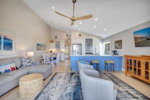 a living room with a couch and a kitchen at Captiva Hide A Way 2B in Captiva